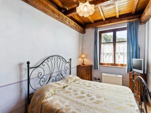 a bedroom with a bed and a tv and a window at Elegant apartment only 1 hour from Rome in Narni