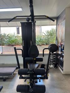 a room with a gym with exercise equipment at Max Savassi Luxury in Belo Horizonte