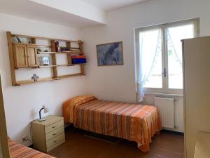 a bedroom with two beds and a window at Etruscan Coast & Rome Gateway in Marina di Cerveteri