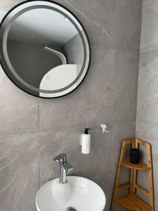 a bathroom with a sink and a mirror on the wall at Lᾶs Serifos in Livadi