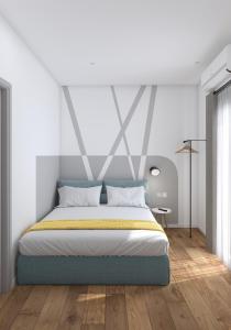 a bed in a white room with at Lᾶs Serifos in Livadi