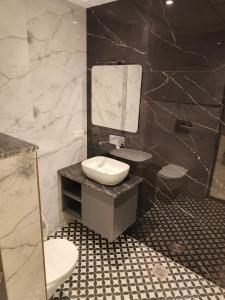 a bathroom with a sink and a mirror at Veda INN by Chrysdorf in Faizābād