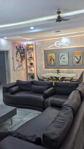 a living room with a couch and a table at Nems Appartment in Ikeja