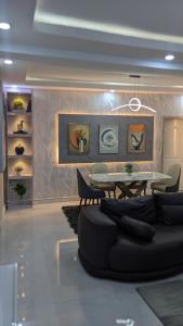a living room with a table and a couch at Nems Appartment in Ikeja