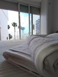 a bedroom with a bed with a view of the ocean at Cencibel - Harbor's Light in Villajoyosa +2 photos