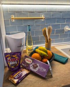 a counter with a bunch of fruit and a bottle of wine at Cencibel - Harbor's Light in Villajoyosa