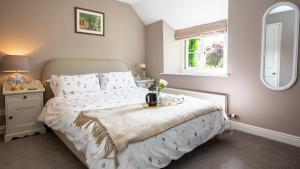 a bedroom with a bed with a tray on it at Honeywick Cottage in Stow on the Wold