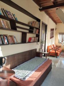 a bed in a room with bookshelves at Hạ Hoàng Hôn House & Coffee in Da Lat