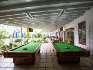 a pool room with two pool tables on a patio at N Hotel in Cagayan de Oro