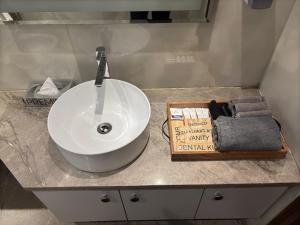 a bathroom counter with a white sink and towels at Housr Sector 42 Gurgaon Golf Course Road Near 42-43 Metro Station in Gurgaon +75 photos