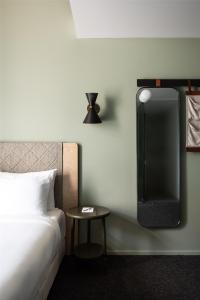 a bedroom with a bed and a table and a tv at Alex Hotel in Perth
