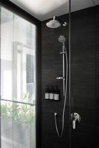 a bathroom with a shower with a glass door at Alex Hotel in Perth