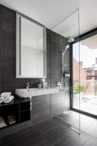 a bathroom with a sink and a shower at Alex Hotel in Perth