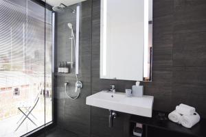 a bathroom with a sink and a shower at Alex Hotel in Perth