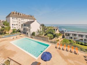 an overhead view of a swimming pool in front of a building at Apartment in Audierne near Trescadec Beach in Audierne