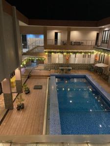 a large swimming pool in a large building at Sumbawa Grand Hotel in Sumbawa Besar