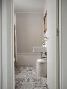 a white bathroom with a sink and a sink at Casa Aurora Vejer in Vejer de la Frontera +39 photos