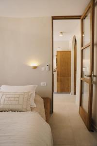 a bedroom with a bed and a door leading to a bathroom at Casa Casolare by The Residence in Bilice +103 photos