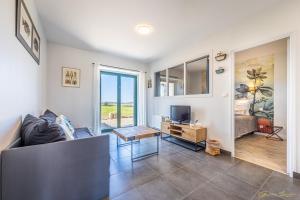 a living room with a couch and a television at Manoir De Rigourdaine in Plouër-sur-Rance