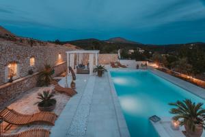 a swimming pool with chairs and a building at Casa Casolare by The Residence in Bilice