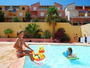 a woman and a child in the swimming pool at a resort at Apartment with Terrace Views in Cerbère +32 photos