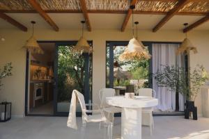 a dining room with a white table and chairs at Casa Casolare by The Residence in Bilice