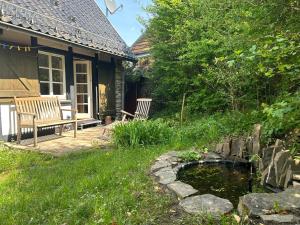 a house with a pond in the yard at Architektur Ferienhaus Eifel SUITE14 in Bad Münstereifel +4 photos