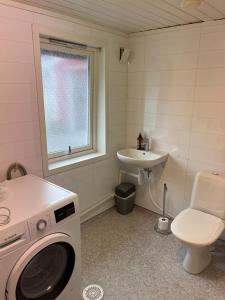 a bathroom with a washing machine and a sink at Drømmebrygga in Averoy +72 photos