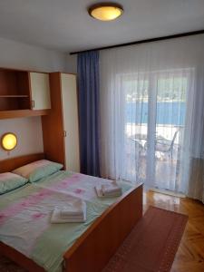 Un pat sau paturi într-o cameră la Ljubica Apartments and Rooms