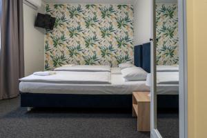 a pair of beds in a room with a mirror at Noclegi Stop and Sleep Zgorzelec in Zgorzelec