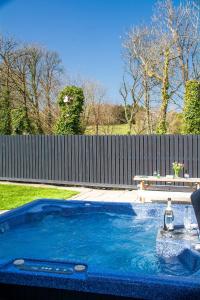 a small swimming pool in a yard with a fence at 80 Breeze Hill in Benllech