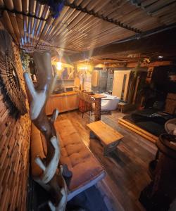 a living room with a statue of a woman on a couch at Captain's Jacuzzi&sauna in Condé-Sainte-Libiaire