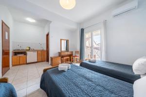 a hotel room with two beds and a kitchen at Roys Blu in Kavos +96 photos
