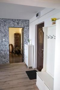 a room with a hallway with a door and a dresser at The Home in Gheorgheni +11 photos