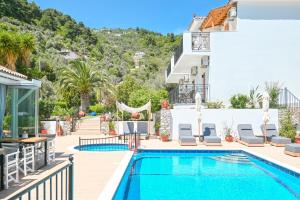 a villa with a swimming pool and a house at SKIATHOS-FILOKALIA in Achladies