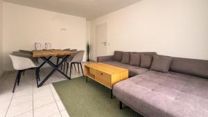 a living room with a couch and a table at Gemütliches Apartment in Velden in Velden am Wörthersee