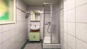 a bathroom with a sink and a shower at Gemütliches Apartment in Velden in Velden am Wörthersee +17 photos