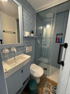 a bathroom with a sink and a toilet and a shower at Viura - Harbor's Light in Villajoyosa