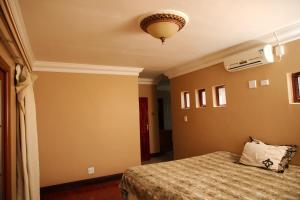 a bedroom with a bed and a ceiling at Un-Furnished Rooms Contractors Accomodation at 66 Pongola Street, MIDDELBURG, Mpumalanga in Middelburg