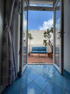 an open door to a balcony with a couch at La Casa del Comandante in Ponza
