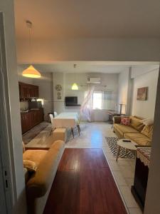 a living room with a couch and a table at Olga Studios in Heraklio Town