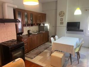 a kitchen with a table and a kitchen with a stove at Olga Studios in Heraklio Town