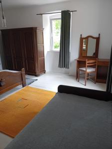 a living room with a table and a mirror at Centrum Nerezine - apartmán in Nerezine +20 photos