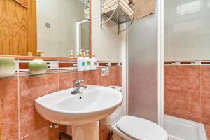 a bathroom with a sink and a toilet and a mirror at Apartamento Fernandita in Nerja +23 photos