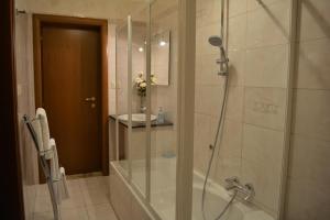 a shower with a glass door in a bathroom at Villa Elena in Montesilvano +28 photos