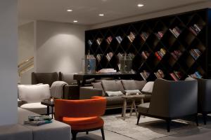a room with a couch and chairs and a wine cellar at Wyndham Stuttgart Airport Messe in Stuttgart
