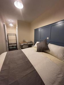 a bedroom with a large bed with a large headboard at Maloney's The Square Bed & Breakfast in Charlestown