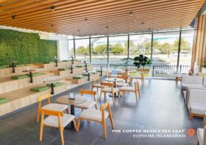 a coffee bar with tables and chairs and windows at Elysium Tower - LMY Executive Hotel Serviced Apartments Facing Centaurus Mall Islamabad in Islamabad