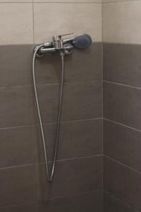 a shower with a shower head in a bathroom at Ionian Blue Apartament II in Himare +64 photos