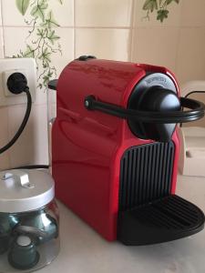 a red toaster sitting on a kitchen counter at Casa da Avenida Lisboa in Lisbon